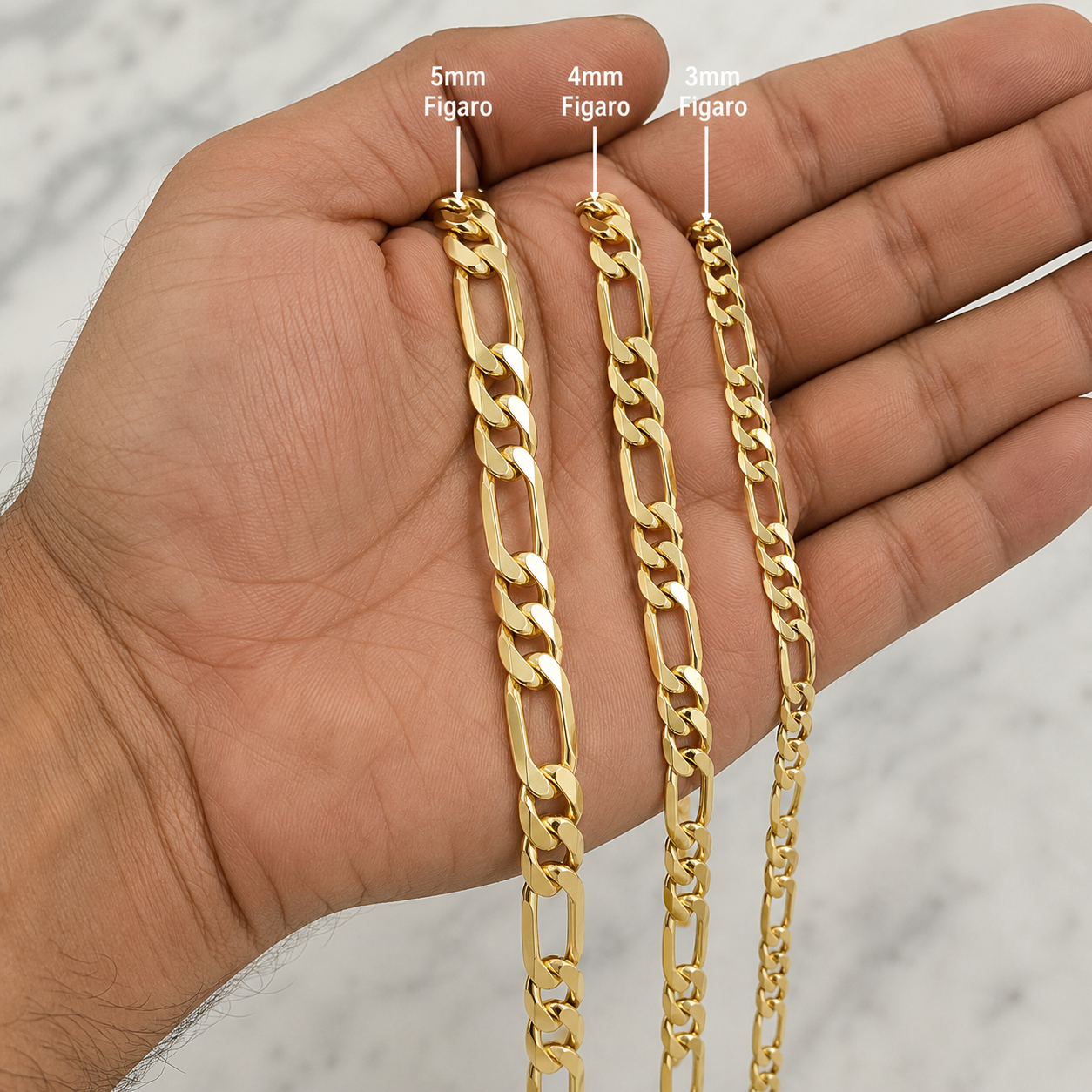 Figaro chain 3mm 4mm 5mm held in hand for scale